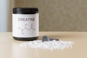 Jar with creatine as a muscle growth supplement